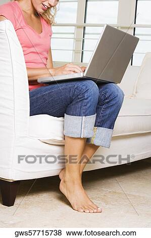 Young woman working on a laptop View Large Photo Image Stock Photo - Young woman working on a laptop. Fotosearch