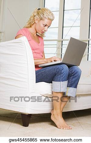 Young woman working on a laptop View Large Photo Image Stock Photography - Young woman working on a laptop. Fotosearch