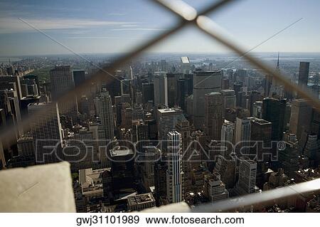 Aerial view of buildings seen through a window grill, New York City, New York State, USA View Large Photo Image Stock Photo - Aerial view of buildings seen through a window grill, New York City, New York State, USA. Fotosearch