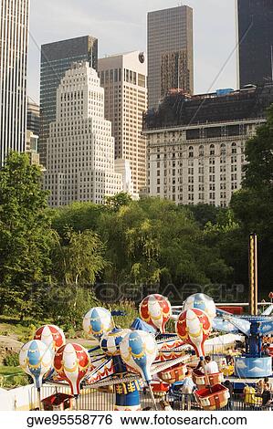 Amusement park ride in front of skyscrapers View Large Photo Image Stock Photograph - Amusement park ride in front of skyscrapers. Fotosearch