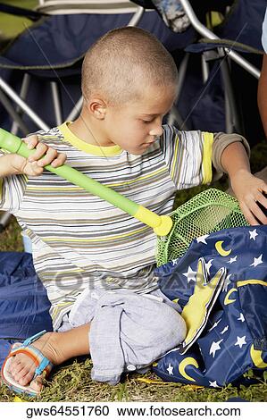 Boy putting a butterfly net into a bag View Large Photo Image Stock Image - Boy putting a butterfly net into a bag. Fotosearch
