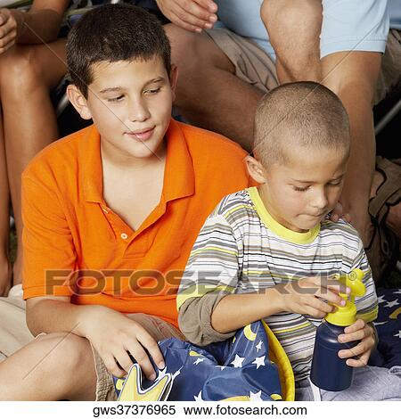 Boy sitting with his brother View Large Photo Image Stock Photography - Boy sitting with his brother. Fotosearch