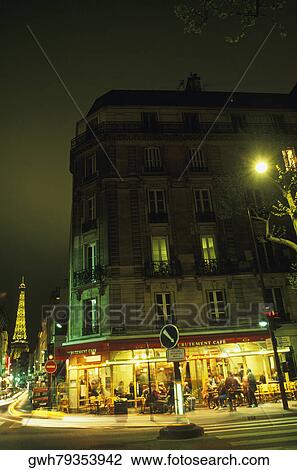 Buildings in front of a tower lit up at night, Eiffel Tower, Paris, France View Large Photo Image Stock Image - Buildings in front of a tower lit up at night, Eiffel Tower, Paris, France. Fotosearch
