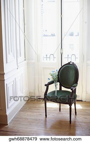 Stock Photo - Bunch of flowers in an armchair. Fotosearch