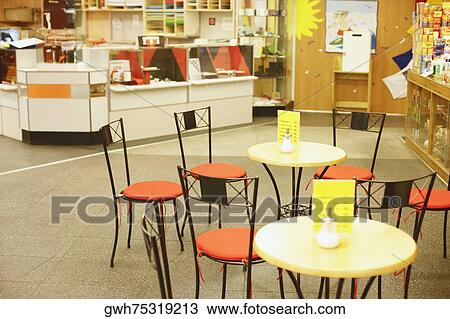 Stock Image - Chairs and tables in a cafe . Fotosearch