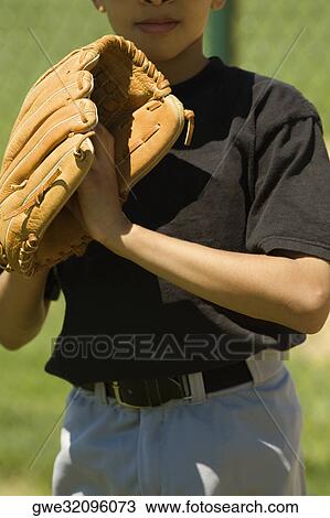 Close-up of a baseball player standing in a baseball field View Large Photo Image Stock Image - Close-up of a baseball player standing in a baseball field. Fotosearch