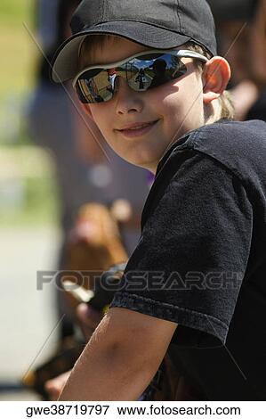 Stock Photo - Close-up of a baseball player wearing sunglasses and smiling. Fotosearch
