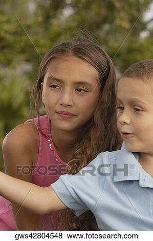 Close-up of a boy and his sister looking sideways View Large Photo Image Stock Photo - Close-up of a boy and his sister looking sideways. Fotosearch