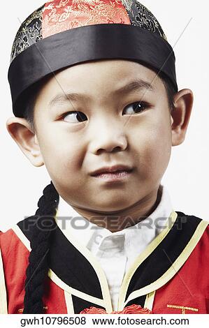 Close-up of a boy looking away View Large Photo Image Stock Photo - Close-up of a boy looking away. Fotosearch