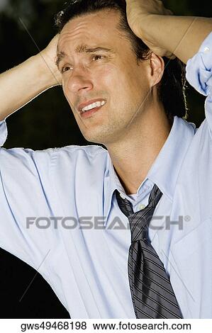 Close-up of a businessman looking worried View Large Photo Image Stock Photo - Close-up of a businessman looking worried. Fotosearch