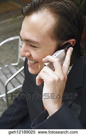 Stock Photography - Close-up of a businessman talking on a mobile phone. Fotosearch