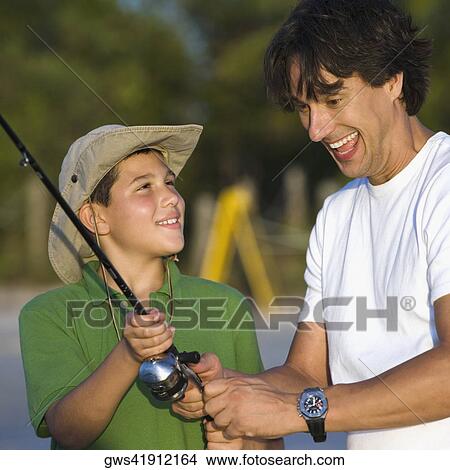 Close-up of a father and his son fishing View Large Photo Image Picture - Close-up of a father and his son fishing. Fotosearch
