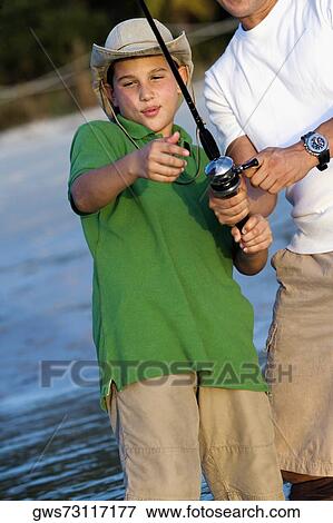 Stock Photo - Close-up of a father and his son fishing. Fotosearch
