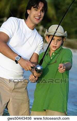 Close-up of a father and his son fishing View Large Photo Image Stock Photograph - Close-up of a father and his son fishing. Fotosearch