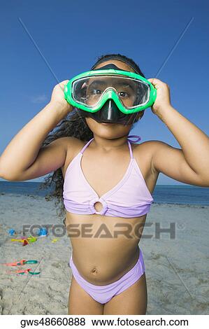 Close-up of a girl standing on the beach and wearing a scuba mask View Large Photo Image Stock Photo - Close-up of a girl standing on the beach and wearing a scuba mask. Fotosearch