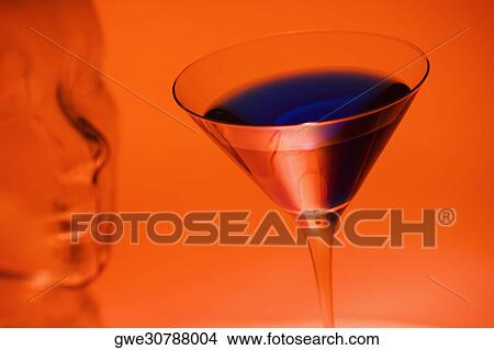 Close-up of a glass of martini near a glass mannequin View Large Photo Image Picture - Close-up of a glass of martini near a glass mannequin. Fotosearch