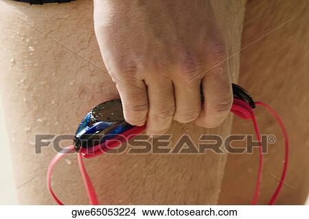 Close-up of a man's hand holding swimming goggles View Large Photo Image Picture - Close-up of a man's hand holding swimming goggles. Fotosearch