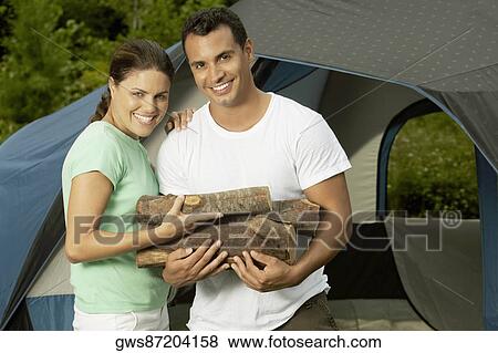 Close-up of a mature couple holding firewood View Large Photo Image Stock Photo - Close-up of a mature couple holding firewood. Fotosearch