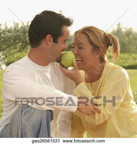 Stock Image - Close-up of a mature man and a young woman smiling. Fotosearch