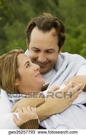 Close-up of a mature man embracing a mid adult woman View Large Photo Image Stock Image - Close-up of a mature man embracing a mid adult woman. Fotosearch
