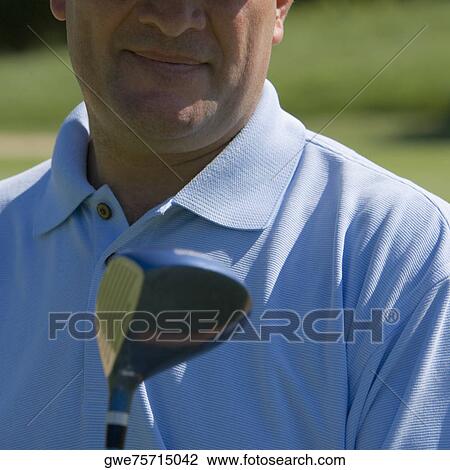 Close-up of a mature man holding a golf club View Large Photo Image Stock Image - Close-up of a mature man holding a golf club. Fotosearch