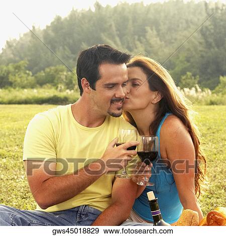 Close-up of a mature woman kissing a mature man and toasting with wine View Large Photo Image Stock Photo - Close-up of a mature woman kissing a mature man and toasting with wine. Fotosearch