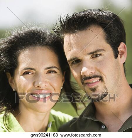 Stock Photo - Close-up of a mid adult couple smiling. Fotosearch