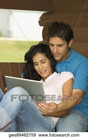 Close-up of a mid adult man and a young woman using a laptop View Large Photo Image Stock Photo - Close-up of a mid adult man and a young woman using a laptop. Fotosearch