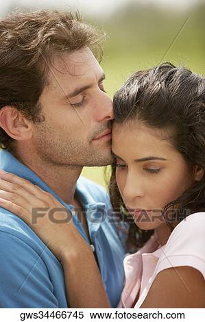 Close-up of a mid adult man embracing a young woman View Large Photo Image Stock Photography - Close-up of a mid adult man embracing a young woman. Fotosearch