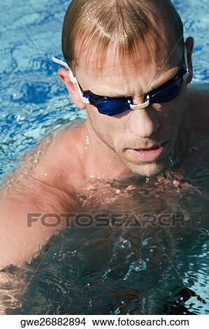 Picture - Close-up of a mid adult man in a swimming pool. Fotosearch