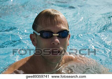 Stock Image - Close-up of a mid adult man in a swimming pool. Fotosearch