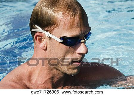 Close-up of a mid adult man in a swimming pool View Large Photo Image Stock Photograph - Close-up of a mid adult man in a swimming pool. Fotosearch