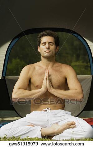 Close-up of a mid adult man in the lotus position View Large Photo Image Stock Photo - Close-up of a mid adult man in the lotus position. Fotosearch