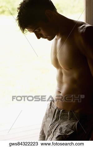 Close-up of a mid adult man leaning against a door View Large Photo Image Stock Image - Close-up of a mid adult man leaning against a door. Fotosearch