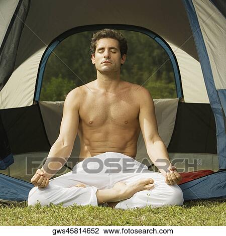 Close-up of a mid adult man sitting in the lotus position View Large Photo Image Stock Image - Close-up of a mid adult man sitting in the lotus position. Fotosearch