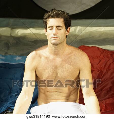 Stock Image - Close-up of a mid adult man sitting with his eyes closed. Fotosearch
