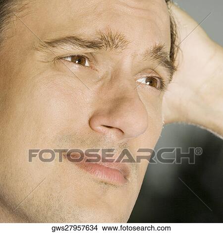 Picture - Close-up of a mid adult man thinking. Fotosearch