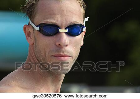 Stock Photograph - Close-up of a mid adult man wearing swimming goggles. Fotosearch