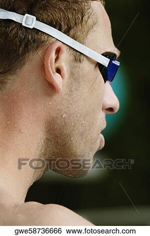 Stock Photograph - Close-up of a mid adult man wearing swimming goggles. Fotosearch
