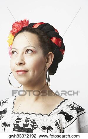 Close-up of a mid adult woman smiling and looking up View Large Photo Image Stock Image - Close-up of a mid adult woman smiling and looking up. Fotosearch