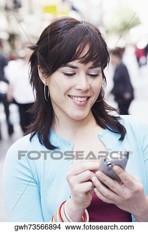 Close-up of a mid adult woman using a personal data assistant View Large Photo Image Picture - Close-up of a mid adult woman using a personal data assistant . Fotosearch