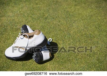 Stock Photograph - Close-up of a pair of golf shoes on the grass. Fotosearch