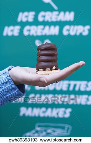 Close-up of a person holding a chocolate View Large Photo Image Stock Image - Close-up of a person holding a chocolate. Fotosearch