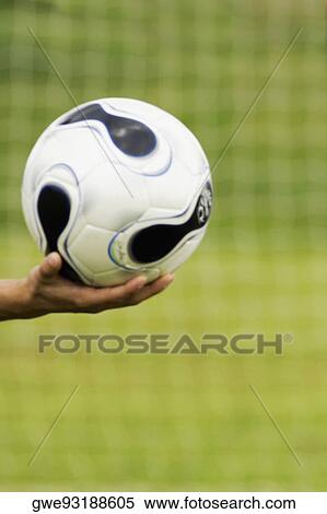 Close-up of a person's hand holding a soccer ball View Large Photo Image Stock Photography - Close-up of a person's hand holding a soccer ball. Fotosearch