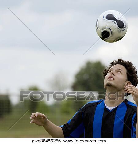 Close-up of a soccer player heading a soccer ball View Large Photo Image Stock Photograph - Close-up of a soccer player heading a soccer ball. Fotosearch