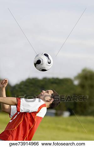 Close-up of a soccer player heading a soccer ball View Large Photo Image Stock Photograph - Close-up of a soccer player heading a soccer ball. Fotosearch