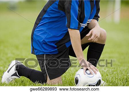 Close-up of a soccer player touching a soccer ball View Large Photo Image Stock Image - Close-up of a soccer player touching a soccer ball. Fotosearch