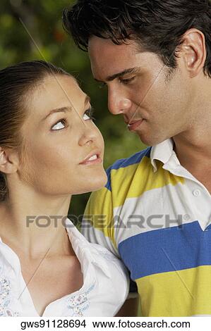 Close-up of a teenage girl and a young man looking at each other View Large Photo Image Picture - Close-up of a teenage girl and a young man looking at each other. Fotosearch