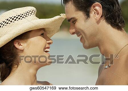 Stock Photo - Close-up of a teenage girl and a young man looking at each other. Fotosearch