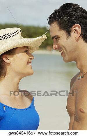 Stock Photo - Close-up of a teenage girl and a young man looking at each other. Fotosearch